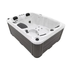 Vista lateral en ángulo de un spa de hidromasaje rectangular Deluxe Range Tahiti, que muestra una carcasa de acrílico blanco brillante, paneles laterales de madera sintética de color gris oscuro, tres reposacabezas negros y varios jets de chorro en el interior.
